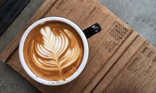 lifestyle image of a coffee mug on a wooden table