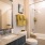 bathroom with a large mirror and ample counter space