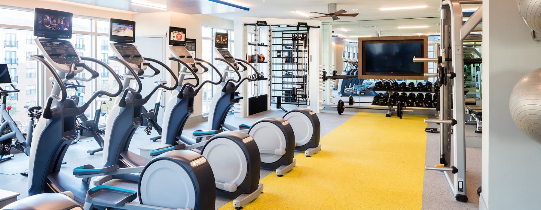 fitness center featuring crossfit equipment, free weights, cardio machines