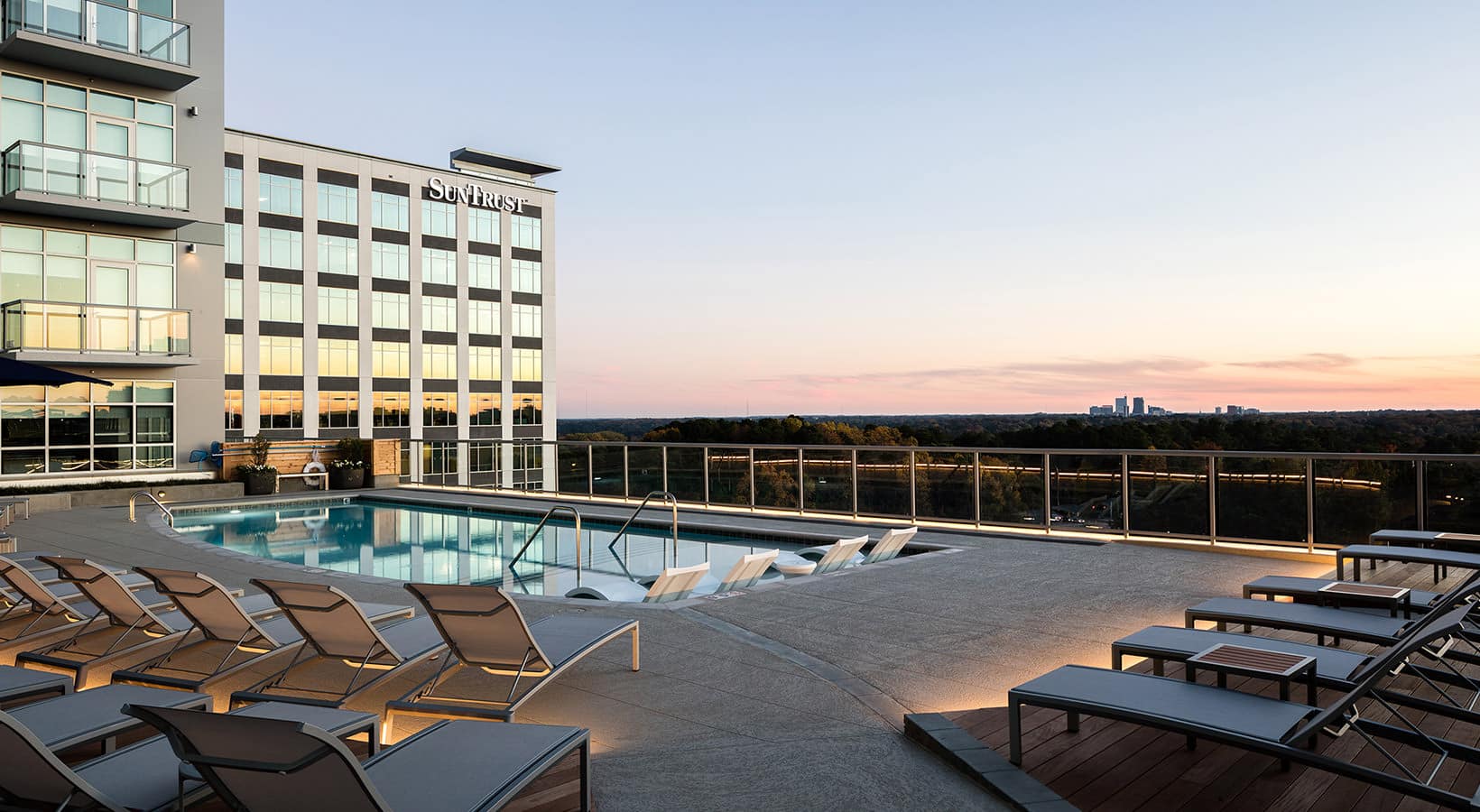 sky deck showing swimming pool and city views at dusk