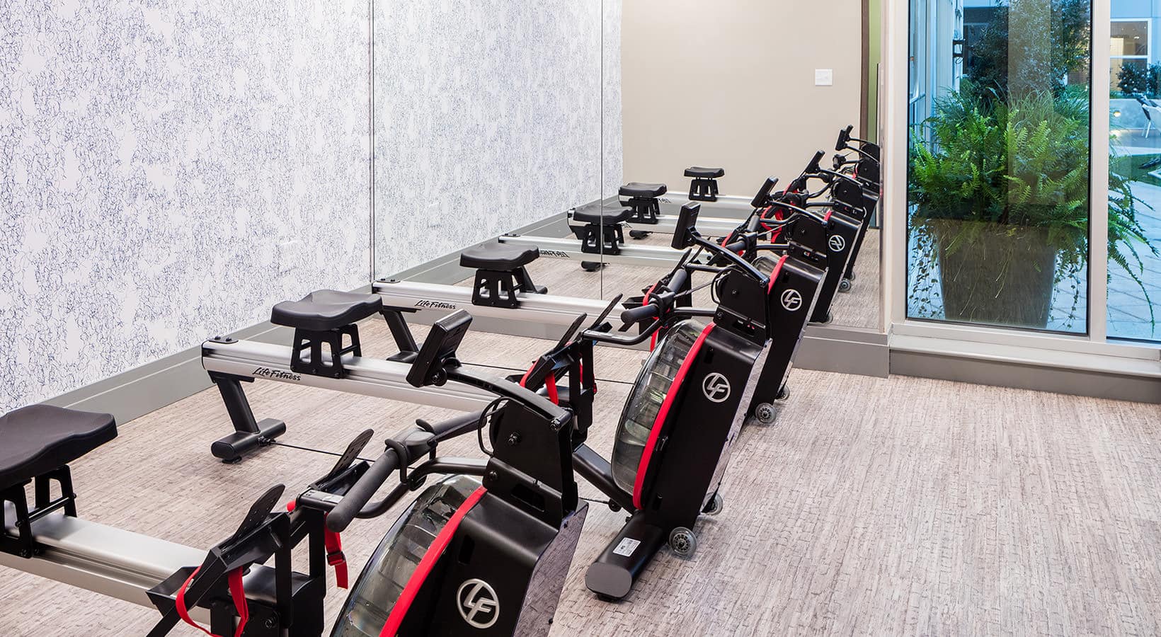 fitness area with row of equipment for working out